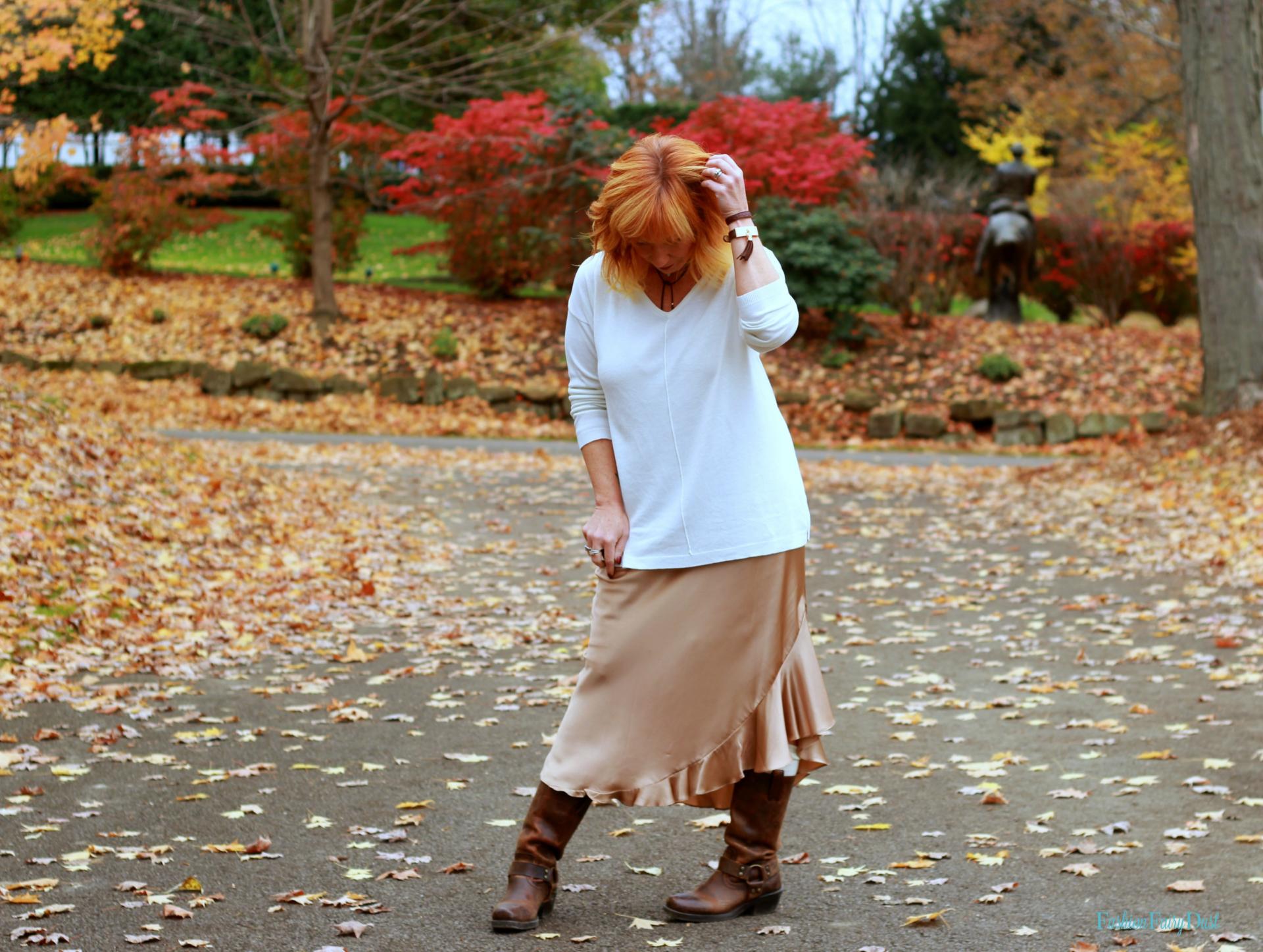 Silk skirt, leather harness boots and sweater. How to add edge to a feminine look.