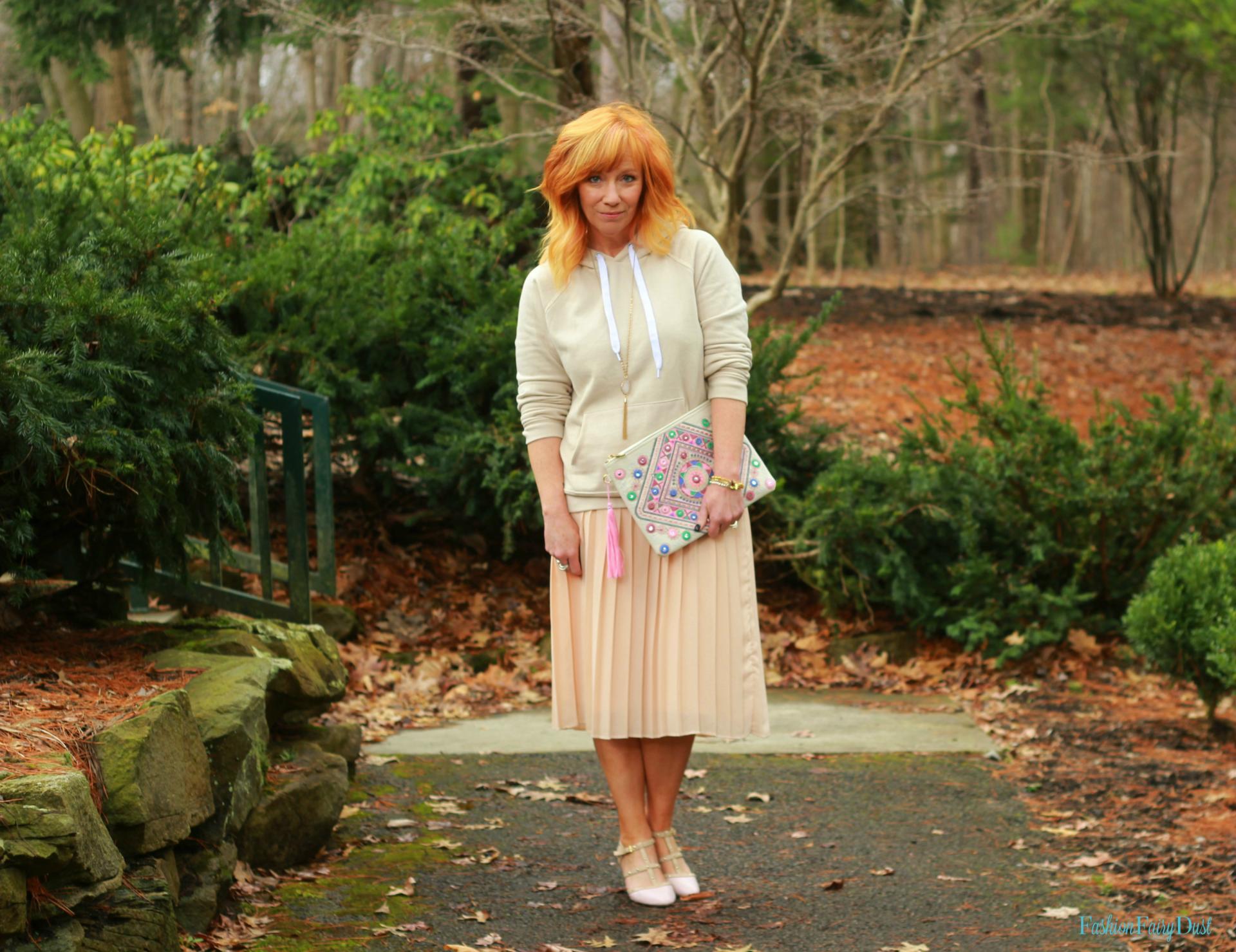 Embroidered clutch, blush pleated skirt and hoodie. How to pair casual with dressy pieces.