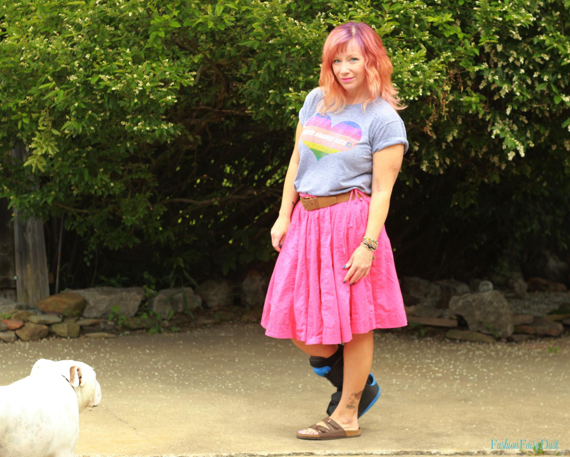 Pride tee shirt, red skirt and Birkenstocks.