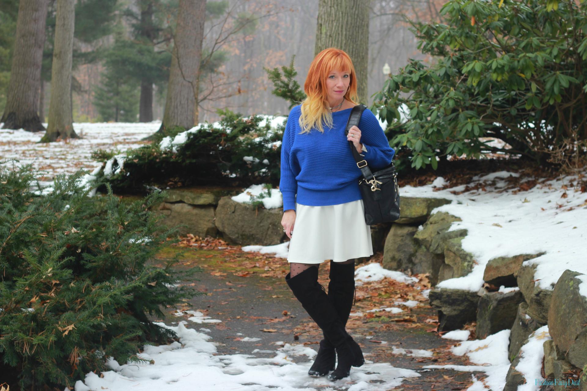 Mod camera bag, blue sweater and white skater skirt.