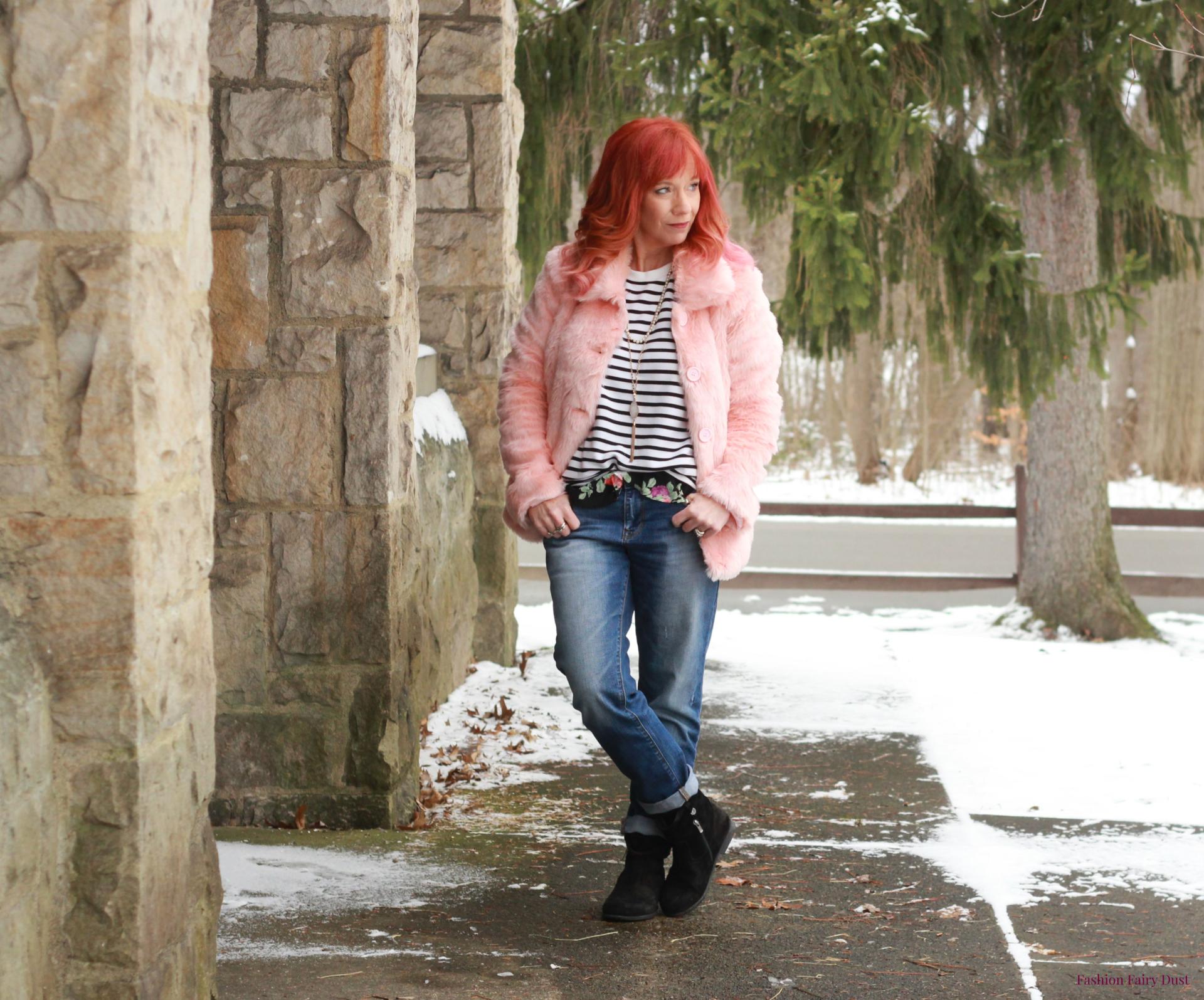 Layered tops, boyfriend jeans and pink faux fur coat.