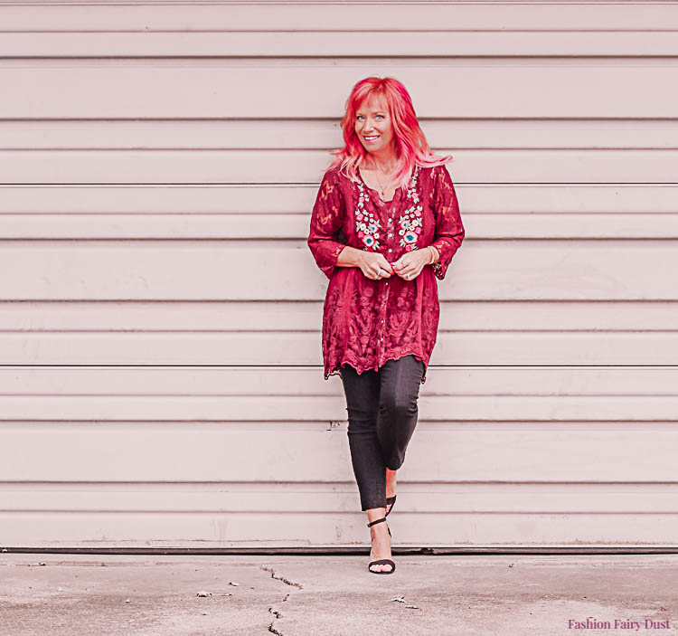 Burgundy lace tunic, black pants and block heel sandals.