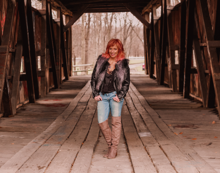 Faux fur vest, moto jacket and over the knee boots.